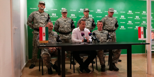 Laszlo Toroczkai, first row center, head of Hungary's far-right Our Homeland Movement, announces the formation of the National Legion, a "self-defense group" created in the spirit of the Hungarian Guard, which was disbanded by the courts in 2009 in Budapest, Hungary, Tuesday, May 14, 2019. The group's main activities will include "guarding of traditions" and teaching basic military skills. (AP Photo/Pablo Gorondi)
