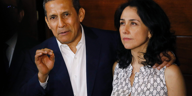 FILE - In this April 30, 2018 file photo, Peru's former President Ollanta Humala accompanied by his wife Nadine Heredia, speaks to reporters at the entrance of their home after they were released from prison, in Lima, Peru. On Tuesday, May 7, 2019, the Peruvian prosecutor's office requested 20 years in prison for former President Ollanta Humala, and 26 years for his wife Nadine Heredia, both who are accused of laundering money they allegedly received from the Brazilian company Odebrecht. (AP Photo/Joel Alonzo, File)