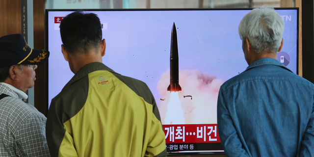 People watch a TV showing a file photo of North Korea's weapon systems during a news program at the Seoul Railway Station in Seoul, South Korea, Thursday, May 9, 2019. North Korea on Thursday fired at least one unidentified projectile from the country's western area, South Korea's military said, the second such launch in the last five days and a possible warning that nuclear disarmament talks could be in danger. (AP Photo/Ahn Young-joon)