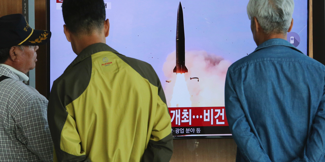 People watch a TV showing a file photo of North Korea's weapon systems during a news program at the Seoul Railway Station in Seoul, South Korea, Thursday, May 9, 2019. North Korea on Thursday fired at least one unidentified projectile from the country's western area, South Korea's military said, the second such launch in the last five days and a possible warning that nuclear disarmament talks could be in danger. (AP Photo/Ahn Young-joon)