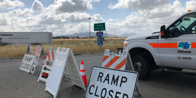 An on ramp to Interstate 215 is closed off on Friday, May 17, 2019, in California. A wide area including the 215 freeway remained off-limits around an F-16 fighter jet crash site in Southern California on Friday as military and civilian authorities investigated. (AP Photo/Amy Taxin)