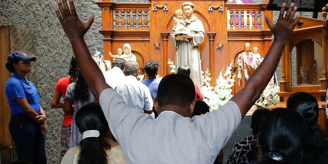 Catholic devotees pray at the St. Anthony's church after it was partially opened for the first time since Easter Sunday attacks, in Colombo, Sri Lanka, Tuesday, May 7, 2019. Two bomb experts were among the suicide attackers who struck churches and hotels on Easter in Sri Lanka and all those directly involved in the bombings are either dead or under arrest, police said. (AP Photo/Eranga Jayawardena)
