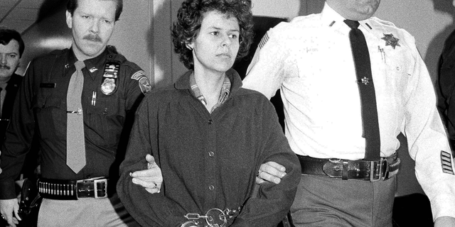 FILE - In this Nov. 24, 1981, file photo, Weather Underground member Judith Clark is handcuffed as she is escorted into Rockland County Courthouse in New City, N.Y. State prison officials say Clark was released Friday, May 10, 2019, from Bedford Hills Correctional Facility in Westchester County. She became eligible for parole consideration after Gov. Andrew Cuomo granted her clemency in 2016, citing her many achievements in prison. (AP Photo/David Handschuh, File)