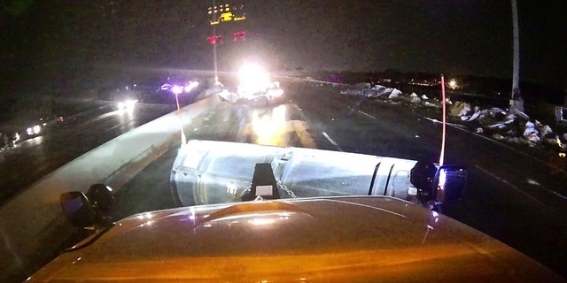This image provided and posted by the Ohio Department of Transportation shows a view from one of the department's trucks as crews on Interstate 75 north of Dayton, Ohio, work to clean debris from the highway after a tornado.