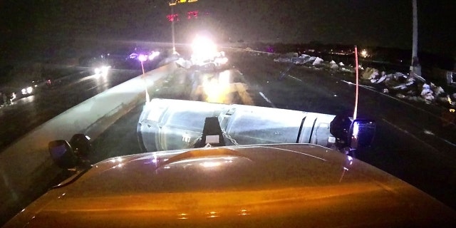 This image provided and posted by the Ohio Department of Transportation shows a view from one of the department's trucks as crews on Interstate 75 north of Dayton, Ohio, work to clean debris from the highway after a tornado.