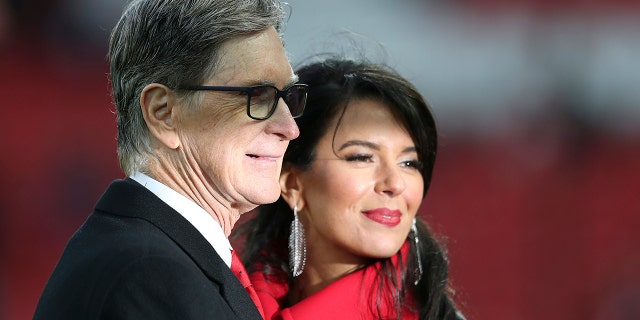 Liverpool FC owner John Henry and his wife Linda Pizzuti pose before the English Premier League soccer match between Liverpool and Huddersfield Town at Anfield Stadium, in Liverpool, England, Friday, April 26, 2019.(AP Photo/Jon Super)