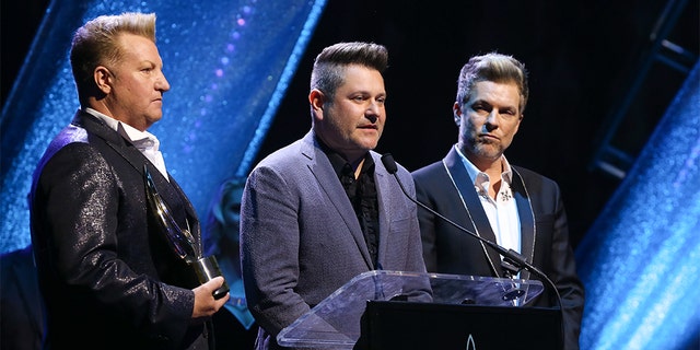 GMA Honorees Gary LeVox, Jay DeMarcus and Joe Don Rooney of Rascal Flatts speak during the 6th Annual GMA Honors and Hall of Fame Ceremony at Allen Arena, Lipscomb University on May 08, 2019 in Nashville, Tenn. (Photo by Terry Wyatt/Getty Images)