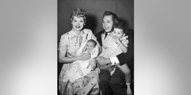 Lucille Ball and her husband, Cuban-born actor Desi Arnaz, laugh and smile while holding their two children, Desi Jr (left) and Lucie, in 1953. (Photo by Hulton Archive/Getty Images)