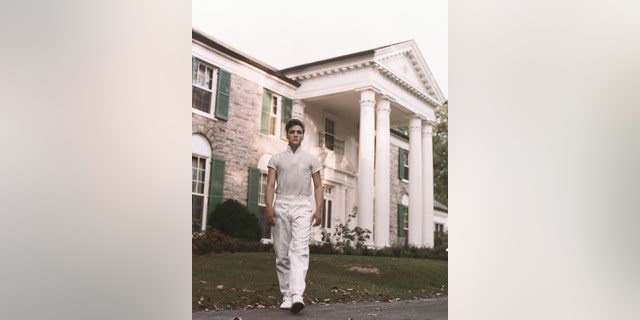 Elvis Presley pictured on the grounds of Graceland not long after he purchased the home in Tennessee.