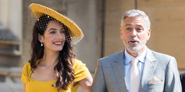 Amal Clooney couldn't help but gush at her husband George Clooney during her virtual book launch on Wednesday. 