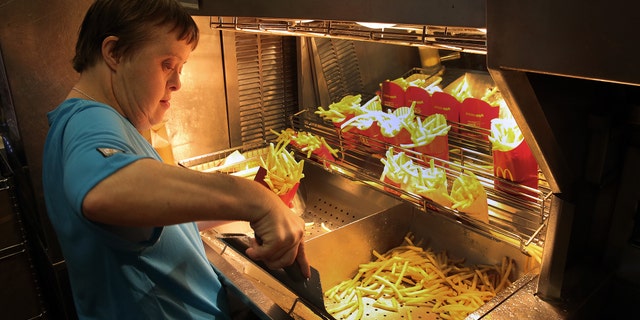 Freia David works the fry station during a retirement celebration.