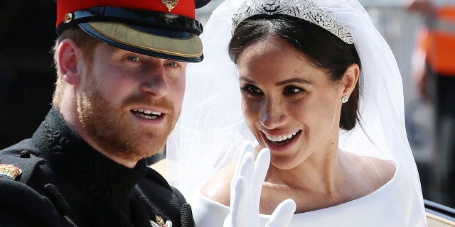 Prince Harry and Meghan Markle ride in an open-topped carriage after their wedding ceremony at St. George's Chapel in Windsor Castle in Windsor, near London, England.