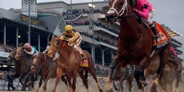 Luis Saez rides Maximum Security, right, across the finish line first against Flavien Prat on Country House during the 145th running of the Kentucky Derby horse race at Churchill Downs Saturday, May 4, 2019, in Louisville, Ky.