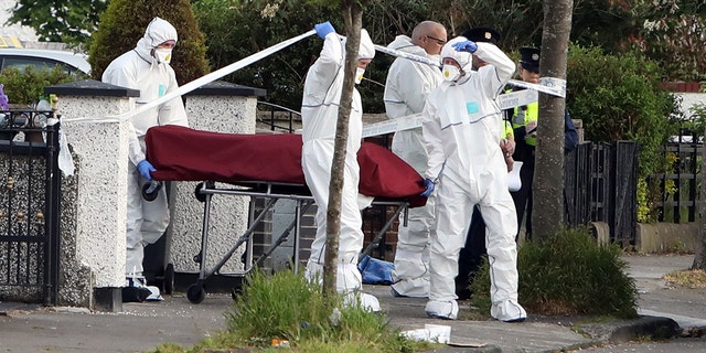 A body, believed to be Sanambar's, is loaded into an ambulance at Kilbarron Avenue where a man was shot dead on Tuesday. (Collins Agency)