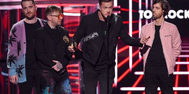 Dan Reynolds, second right, and Daniel Platzman, from left, Ben McKee, and Wayne Sermon, of Imagine Dragons, accept the award for top rock artist at the Billboard Music Awards on Wednesday, May 1, 2019, at the MGM Grand Garden Arena in Las Vegas. (Photo by Chris Pizzello/Invision/AP)
