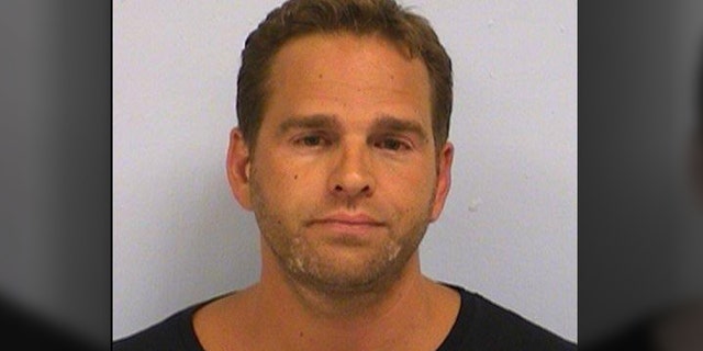 Kyle Gerald Prall, 40, pleaded guilty to one count of mail fraud after admitting that in 2015 and 2016 he created several political action committees and falsely advertised that contributions would support the presidential candidates during the 2016 election, the Department of Justice said Thursday. He is pictured here after being charged on July 15, 2015, with driving while intoxicated.