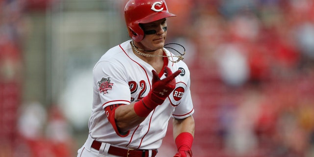 Cincinnati Reds' Derek Dietrich (22) points as he rounds the bases with a two-run home run off Pittsburgh Pirates starting pitcher Jordan Lyles during the fourth inning of a baseball game, Tuesday, May 28, 2019, in Cincinnati. (AP Photo/Gary Landers)
