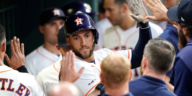Houston Astros' George Springer is congratulated in the dugout after hitting a home run against the Cleveland Indians during the third inning of a baseball game Thursday, April 25, 2019, in Houston. (AP Photo/David J. Phillip)