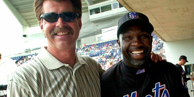 FILE - In this March 29, 2001, file photo, New York Mets coach Mookie Wilson poses with former Boston Red Sox player Bill Buckner in Port St. Lucie, Fla. (AP Photo/Ron Frehm, File)