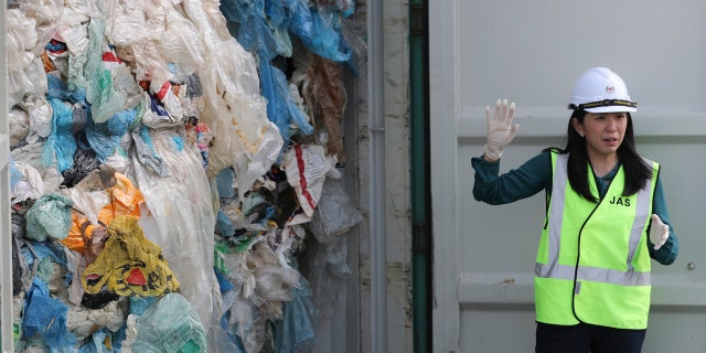Malaysia's Minister of Energy, Science, Technology, Environment and Climate Change Yeo Bee Yin shows plastic waste shipment in Port Klang, Malaysia, Tuesday, May 28, 2019. (AP Photo / Vincent Thian)