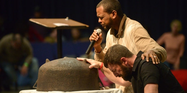 Will Ford and Matt Lockett pray with in the same posture as Ford's ancestors who prayed that one day the next generation or the one after would know freedom.
