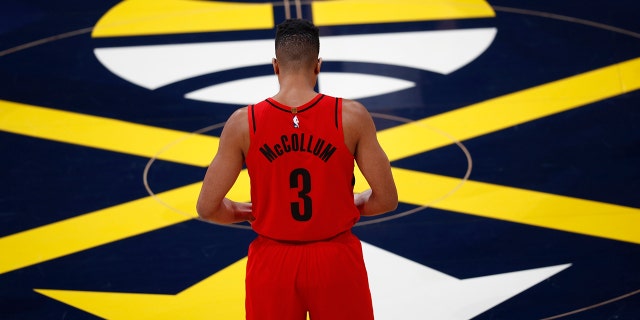 Portland Trail Blazers guard CJ McCollum stands at center court waiting for the start of the first half of Game 7 of an NBA basketball second-round playoff series against the Denver Nuggets Sunday, May 12, 2019, in Denver. (AP Photo/David Zalubowski)