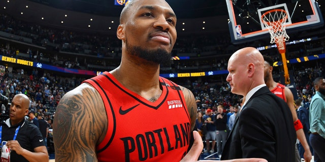 Portland Trail Blazers guard Damian Lillard celebrates after the second half of Game 7 of an NBA basketball second-round playoff series Sunday, May 12, 2019, in Denver. The Trail Blazers won 100-96. (AP Photo/John Leyba)