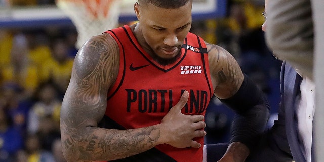 Portland Trail Blazers guard Damian Lillard walks to the bench during the second half of Game 2 of the team's NBA basketball playoffs Western Conference finals against the Golden State Warriors in Oakland, Calif., Thursday, May 16, 2019. (AP Photo/Jeff Chiu)