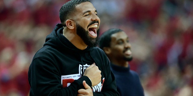 Drake smiles as he watches the Toronto Raptors take on the Milwaukee Bucks during the first half of Game 4 of the NBA basketball playoffs Eastern Conference finals. (Frank Gunn/The Canadian Press via AP)