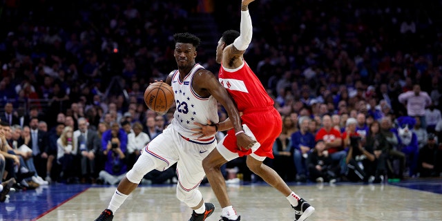 Philadelphia 76ers' Jimmy Butler, left, tries to get past Toronto Raptors' Patrick McCaw during the first half of Game 6 of a second-round NBA basketball playoff series Thursday, May 9, 2019, in Philadelphia. (AP Photo/Chris Szagola)