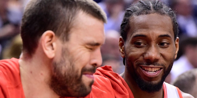 Toronto Raptors forward Kawhi Leonard, right, and center Marc Gasol smiles during the second half of Game 5 of the team's NBA basketball second-round playoff series against the Philadelphia 76ers, Tuesday, May 7, 2019, in Toronto. (Frank Gunn/The Canadian Press via AP)
