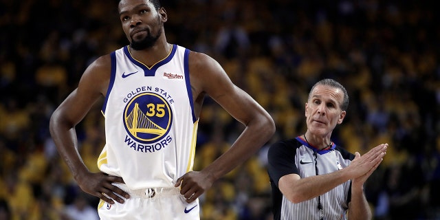 Golden State Warriors' Kevin Durant, left, walks away from referee Ken Mauer during the first half of Game 5 of the team's second-round NBA basketball playoff series against the Houston Rockets on Wednesday, May 8, 2019, in Oakland, Calif. (AP Photo/Ben Margot)