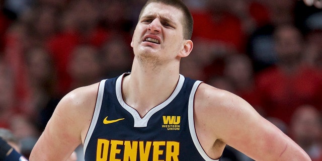 Denver Nuggets center Nikola Jokic grimaces as he walks off the court against the Portland Trail Blazers during the first half of Game 4 of an NBA basketball second-round playoff series, Sunday, May 5, 2019, in Portland, Ore. The Nuggets won 116-112. (AP Photo/Craig Mitchelldyer)