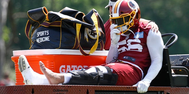 Washington Redskins linebacker Reuben Foster rides a cart off the field after suffering an injury during a practice at the team's NFL football practice facility. (AP Photo/Patrick Semansky)