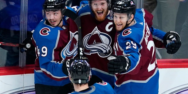 Colorado Avalanche left wing Gabriel Landeskog (92) is congratulated by teammates Samuel Girard (49), Nathan MacKinnon (29) and Cale Makar (8) after scoring a game-winning, overtime goal against the San Jose Sharks in Game 6 of an NHL hockey second-round playoff series, Monday, May 6, 2019, in Denver. Colorado won 4-3 in overtime. (AP Photo/Jack Dempsey)