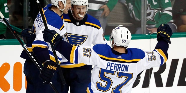 St. Louis Blues' Sammy Blais is congratulated by teammates Jay Bouwmeester, left, and David Perron (57) after scoring during the third period in Game 6 of an NHL second-round hockey playoff series against the Dallas Stars, Sunday, May 5, 2019, in Dallas. The Blues won 4-1. (AP Photo/Tony Gutierrez)