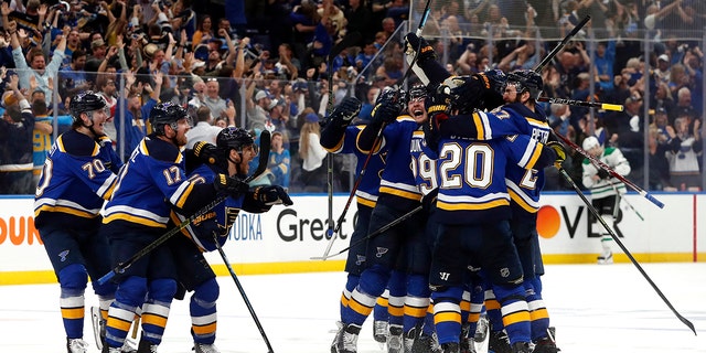 St. Louis Blues celebrate after defeating the Dallas Stars in double overtime in Game 7 of an NHL second-round hockey playoff series Tuesday, May 7, 2019, in St. Louis. The Blues won 2-1. (AP Photo/Jeff Roberson)