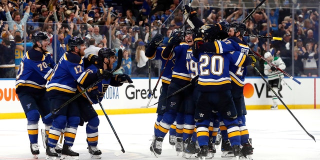 St. Louis Blues celebrate after defeating the Dallas Stars in double overtime in Game 7 of an NHL second-round hockey playoff series Tuesday, May 7, 2019, in St. Louis. The Blues won 2-1. (AP Photo/Jeff Roberson)
