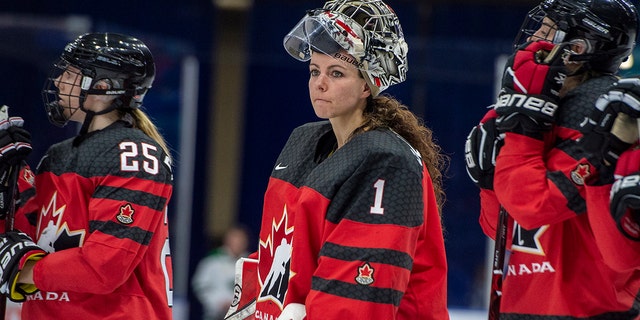 FILE - In this Nov. 10, 2018, file photo, Canada goaltender Shannon Szabados watch as U.S. players celebrate a win during the Four Nations Cup hockey gold-medal game in Saskatoon, Saskatchewan. (Liam Richards/The Canadian Press via AP)