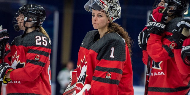 FILE - In this Nov. 10, 2018, file photo, Canada goaltender Shannon Szabados watch as U.S. players celebrate a win during the Four Nations Cup hockey gold-medal game in Saskatoon, Saskatchewan. (Liam Richards/The Canadian Press via AP)