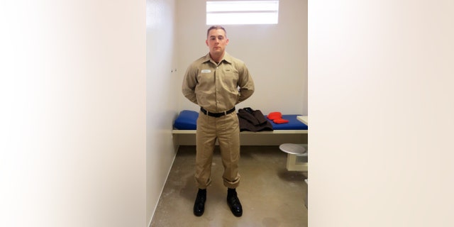 Yeoman 2nd Class John LeBaron, corrections specialist, Naval Consolidated Brig Chesapeake, models the new post-trial standardized prisoner uniform.