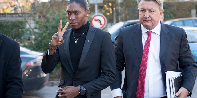 Caster Semenya, left, current 800-meter Olympic gold medalist and world champion, and her lawyer Gregory Nott, right, arrive for the first day of a hearing at the international Court of Arbitration for Sport, CAS, in Lausanne, Switzerland. (Laurent Gillieron/Keystone via AP, File)