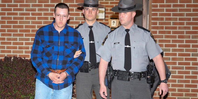 Thomas Dewald is escorted by Pennsylvania State troopers Monday night, April 29, 2019 after being charged in two recent cases in the Rouzerville, Pa. area.