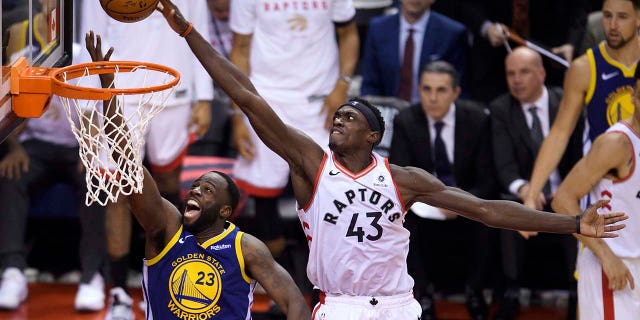 Toronto Raptors forward Pascal Siakam (43) blocks a shot by Golden State Warriors forward Draymond Green (23) during the second half of Game 1 of basketball’s NBA Finals, Thursday, May 30, 2019, in Toronto. (Associated Press)
