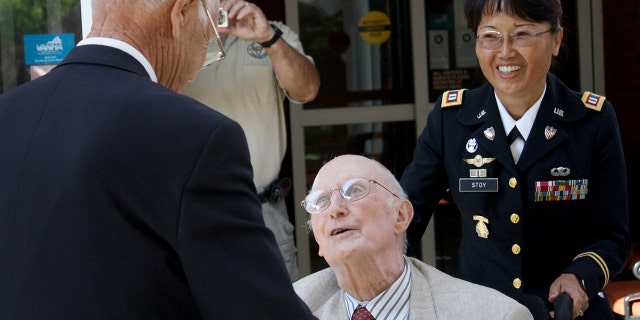 Gen. Lloyd Ramsey, right, reunites with Robert Maxwell, left, at the Brandon Oaks Assistant Living Center in Roanoke, Va. The two had not seen each other since Maxwell threw his body on to a grenade during WWII, saving the lives of Ramsey and several others. (AP Photo/The Roanoke Times, Matt Chittum)