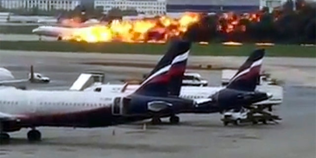 This image taken from video provided by Instagram user @artempetrovich, shows an Aeroflot Airlines flight on fire during an emergency landing in Sheremetyevo airport in Moscow, Russia.