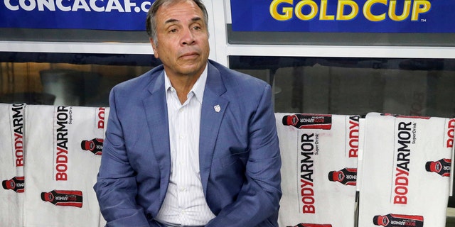 FILE - In this July 22, 2017, file photo, United States head coach Bruce Arena sits on the bench prior to a CONCACAF Gold Cup semifinal soccer match against Costa Rica, in Arlington, Texas. The New England Revolution have hired five-time MLS Cup winner and former U.S. national coach Bruce Arena as its coach and sports director. (AP Photo/LM Otero, File)