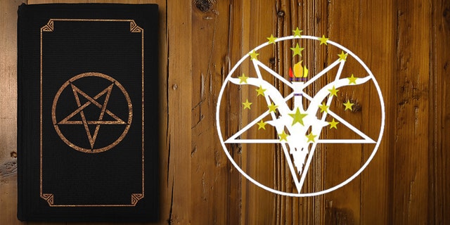 Close-up on a black book with an inverse pentagram on a brown wooden board.