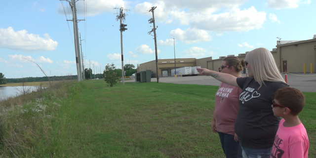 Rebeca Stewart and Sandra Martinez showed the flooding to their kids in Fort Smith.