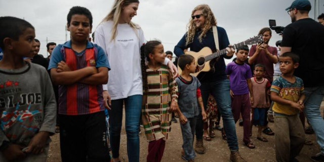 Bethel Music worship leaders Bethany Wohrle and Sean Feucht play music with refugees as part of the "Light A Candle Project."